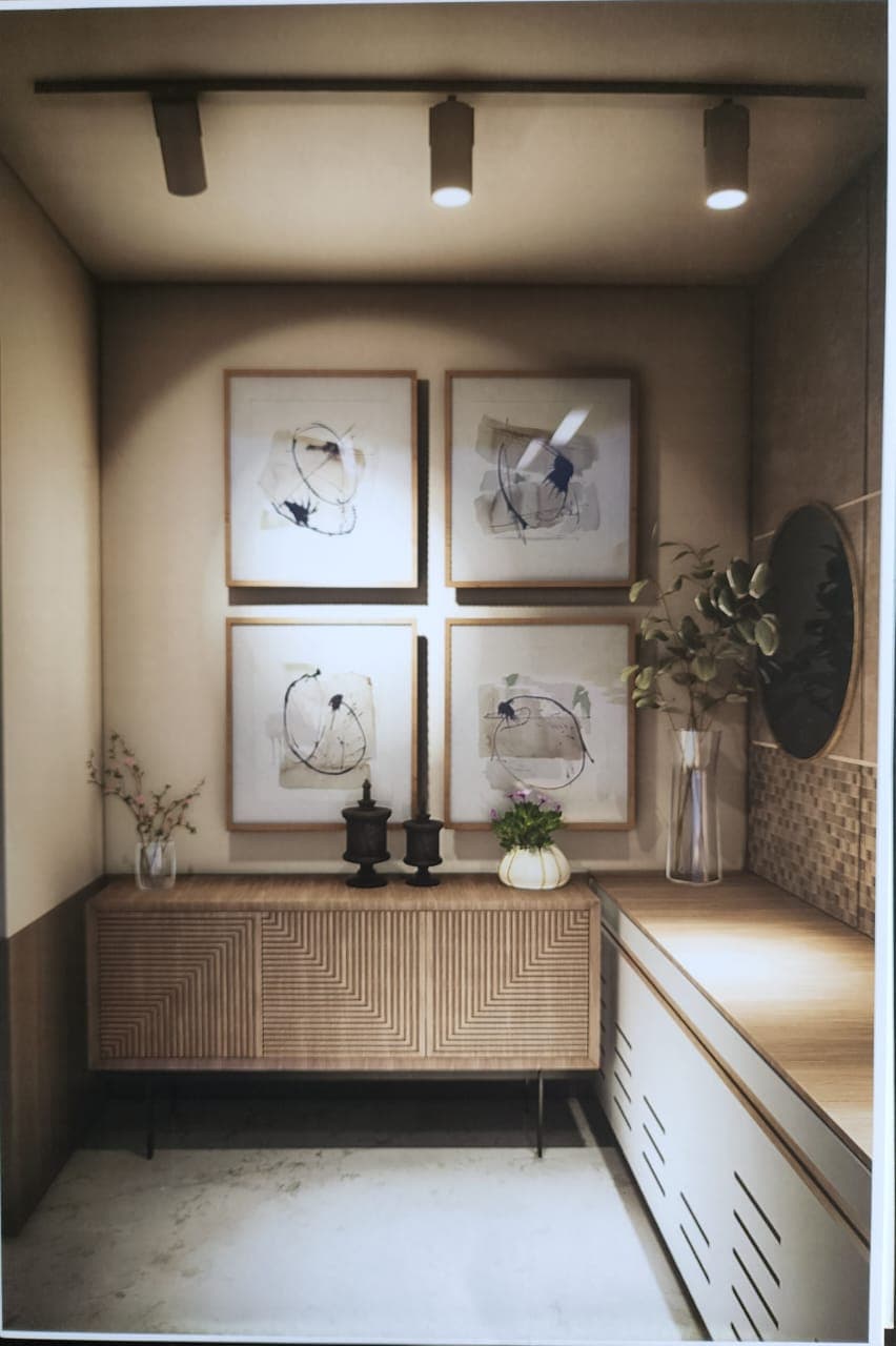 Entrance lobby of an A.S.G. residence, with a fluted console, framed artwork and a round mirror